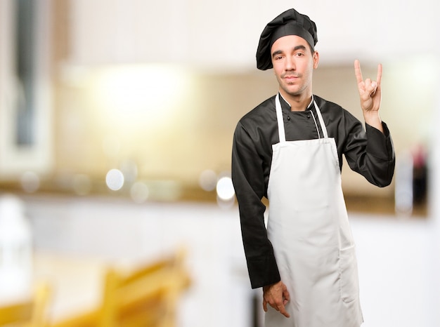 Cool young chef posing