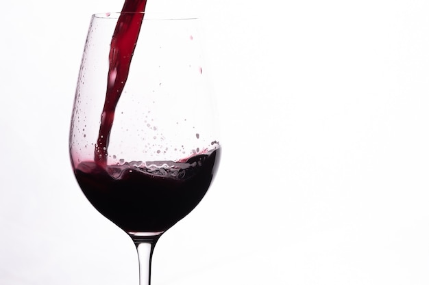 Copa de vino tinto. Verter el alcohol rojo en un vaso. Chorrito de vino tinto.