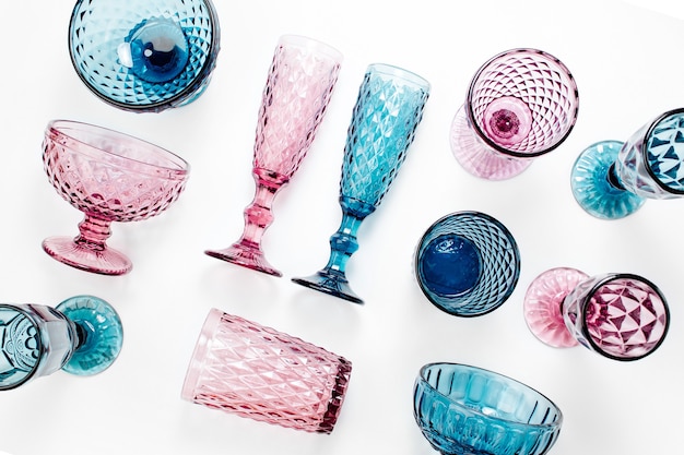 Copas de bebida de colores en relieve para vino y champán sobre fondo blanco.
