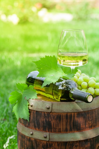 Copo de garrafa de vinho com vinho branco e uva