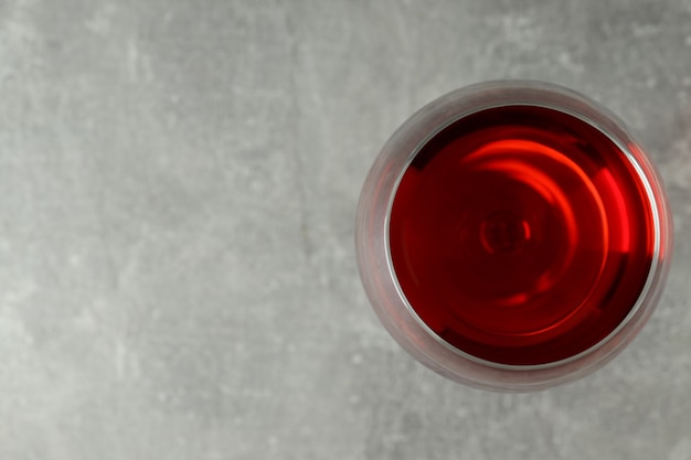 Copo de vinho tinto em plano de fundo texturizado cinza