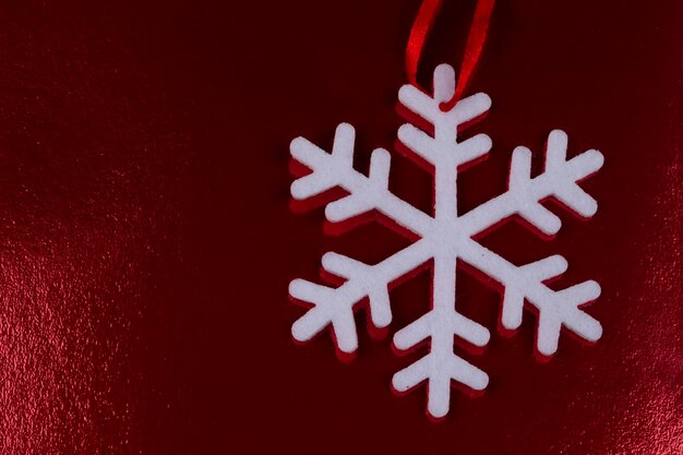 Copo de nieve blanco sobre un fondo rojo brillante de Navidad