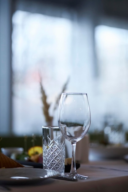 copos em uma mesa servida com uma toalha de mesa branca copos em uma mesa servida
