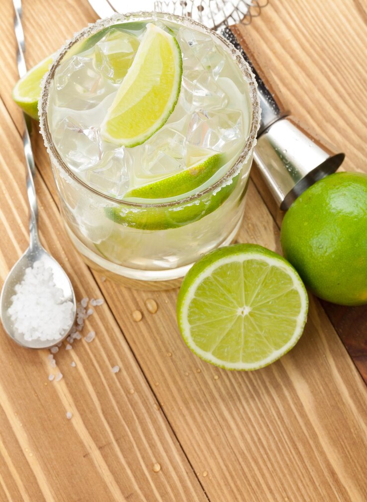 Coquetel clássico de margarita com borda salgada em mesa de madeira