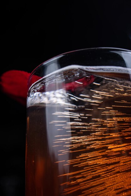 Foto coquetel cuba libre com gelo e papoula vermelha em fundo de madeira escura