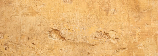 Cor amarela bege pintada e fundo de textura de parede desbotada grunge
