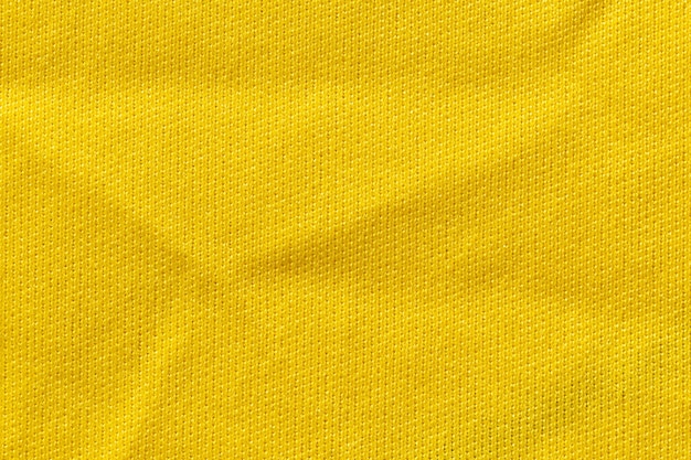 Cor amarela roupas esportivas tecido tecido futebol camisa jersey textura e fundo de têxteis.