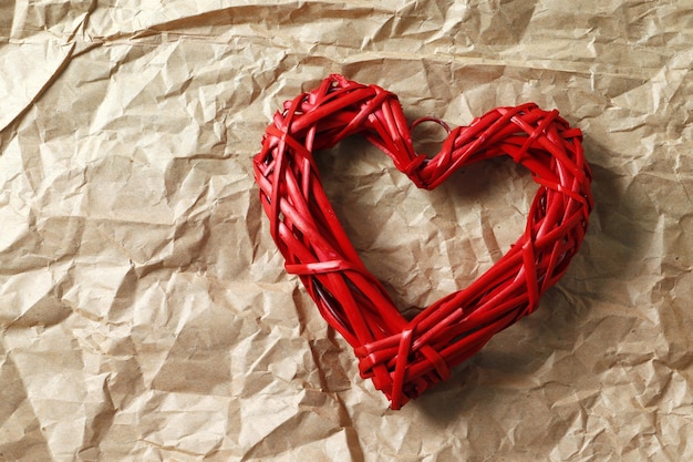 Corazón rojo decorativo sobre papel artesanal. Confesión de amor. Celebración del día de san valentín