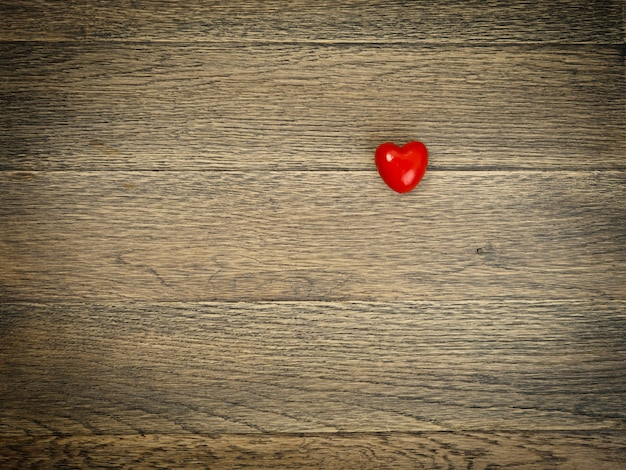 Corazón rojo sobre fondo de madera con espacio para texto