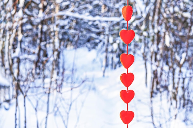 Corazones rojos se encuentran en la nieve el día de San Valentín.