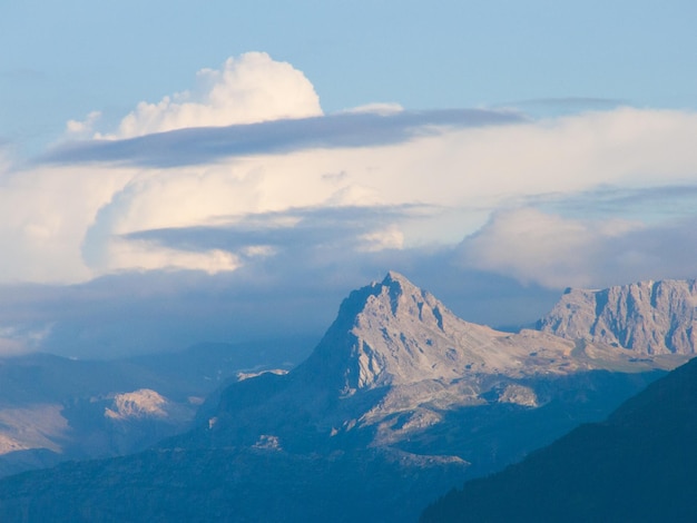 Una cordillera con una nube en el cielo