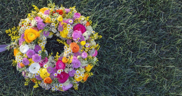 Coroa de flores na grama verde Flores silvestres frescas e gramado de jardim de ervas em cima Dia de primavera