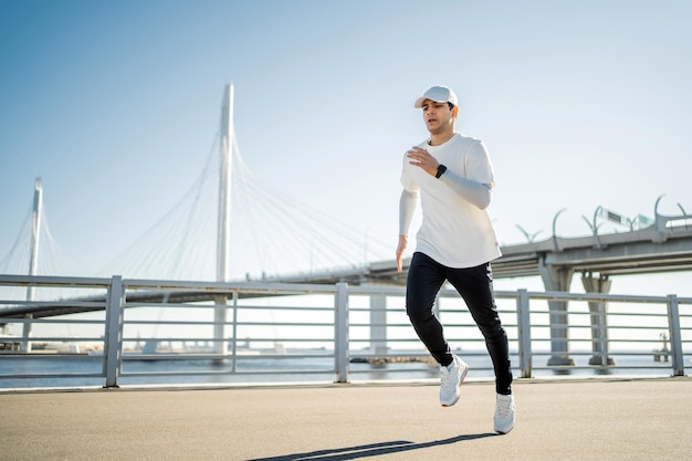 Correr atleta masculino realiza entrenamiento físico en la calle en la ciudad Estilo de vida saludable