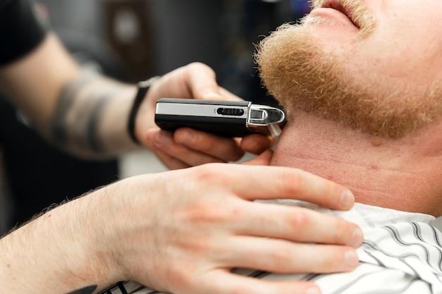 Cortadora de barba corte de pelo de primer plano en la barbería concepto de barbería