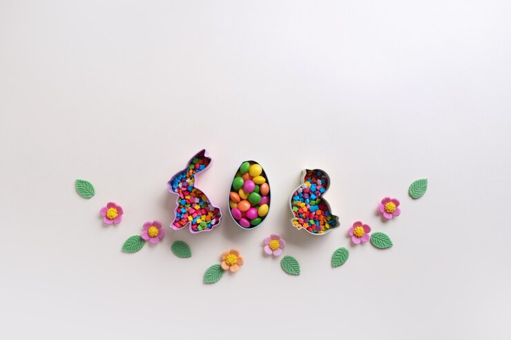 Foto cortadores de galletas de pascua y decoraciones dulces. fondo festivo de pascua. endecha plana. concepto de vacaciones mínimo con espacio para texto.
