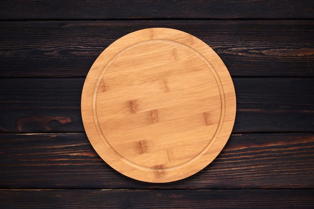 Foto cortar la tabla de madera en la mesa de la cocina de madera