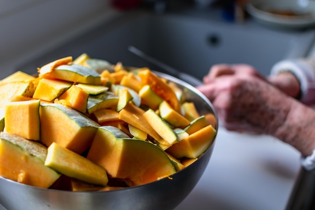 Cortar uma abóbora na cozinha para cozinhar e congelar