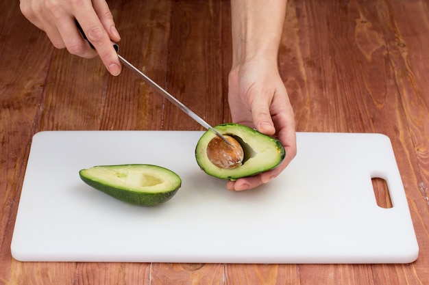 Cortar las verduras con un cuchillo de cocina en el tablero