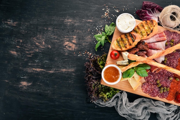 Corte de carne y bocadillos fríos Cocina italiana Sobre un fondo de madera Vista superior Espacio de copia