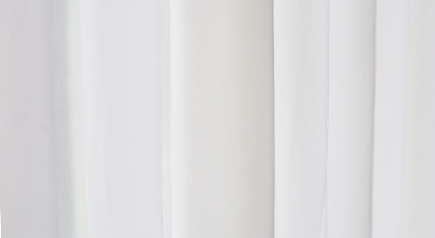 Foto cortina blanca con luz suave desde la ventana.