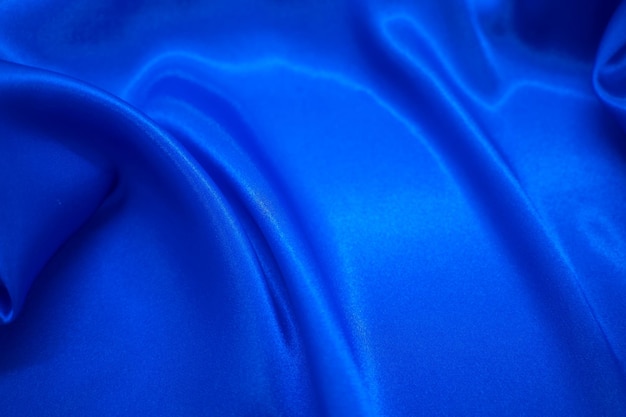 Cortina de tela de tela sedosa de satén azul abstracto con fondo de pliegues ondulados de pliegue