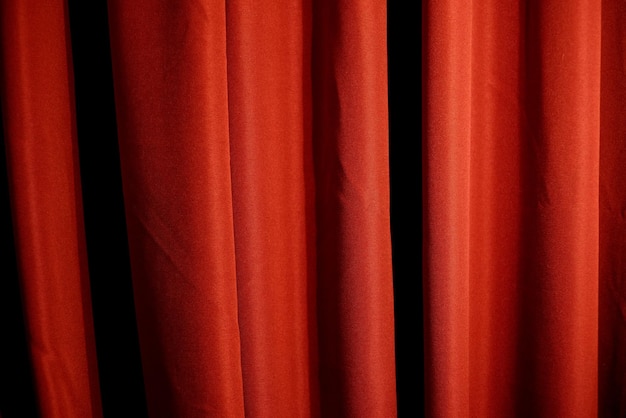 Cortina vermelha fechada com pontos de luz em um teatro Cortina vermelha em veados de teatro ou cinema