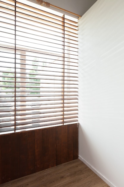 Foto cortinas de madeira com luz do sol em uma sala de casa