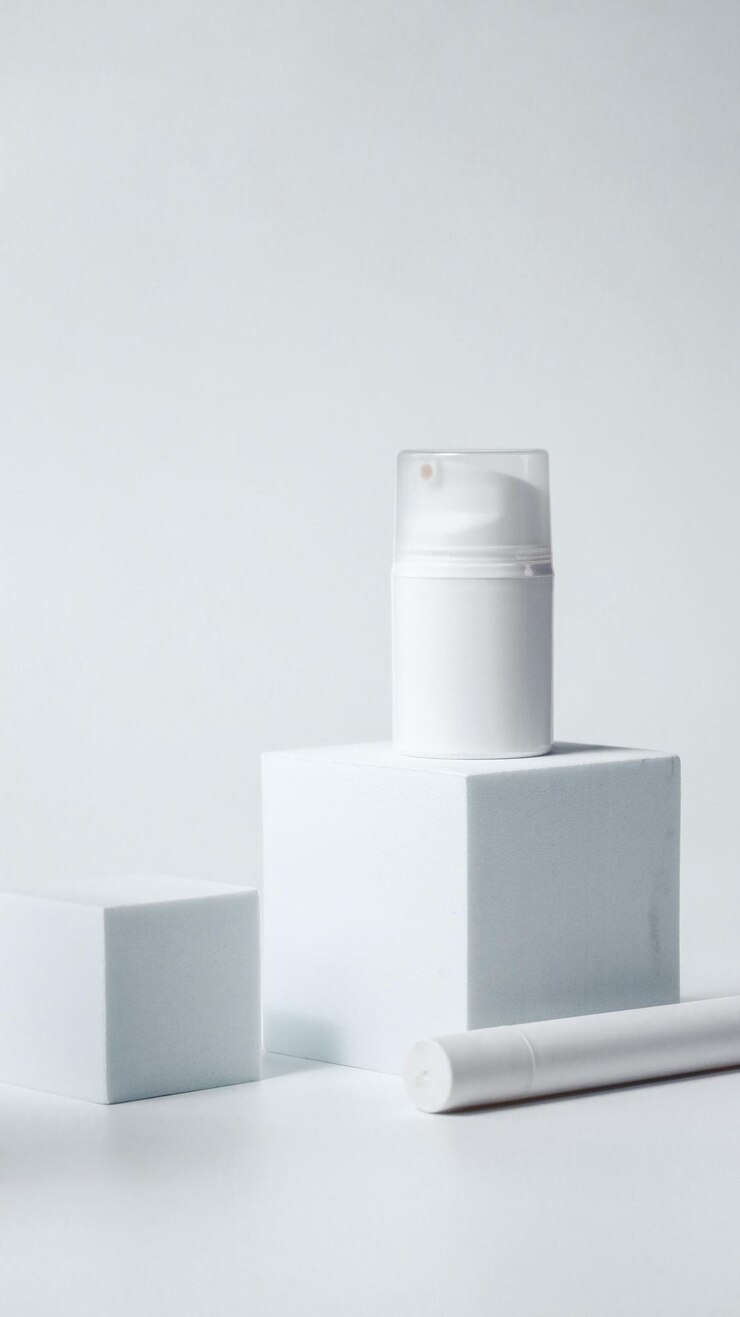 Cosméticos de lujo en una maqueta de podio blanco