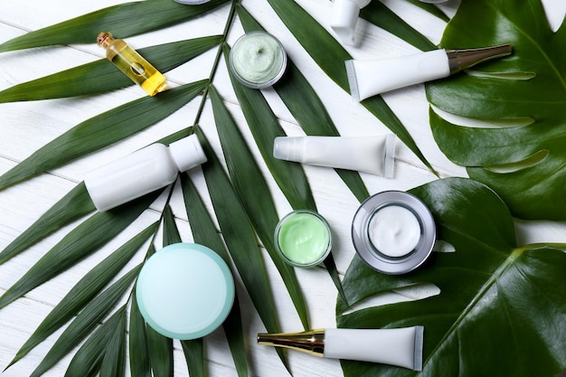 Cosméticos naturais e folhas na mesa