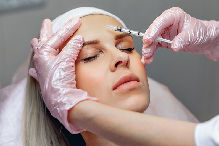 Cosmetologista realizando injeções de Botox para rejuvenescer a parte frontal do rosto.