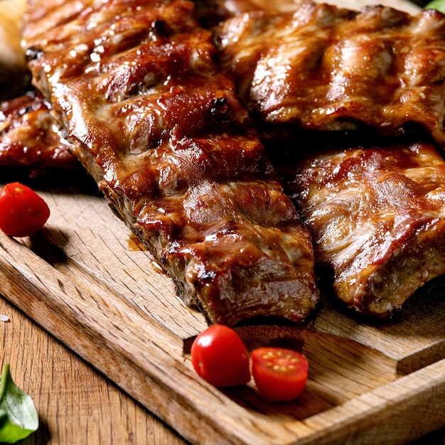 Costelas de churrasco de porco grelhadas servidas com tomate cereja