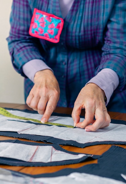 Costureira de mulher com desenho de alfaiate para um terno em cima da mesa