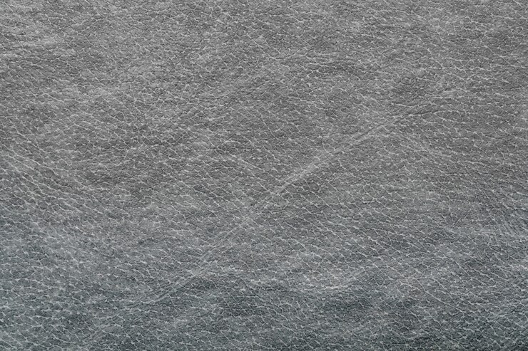 Couro sintético cinza escuro para o fundo. Visualização de macro fotografia de detalhes de close-up do material de decoração de textura, design de plano de fundo padrão para cartaz, folheto, livro de capa e catálogo.