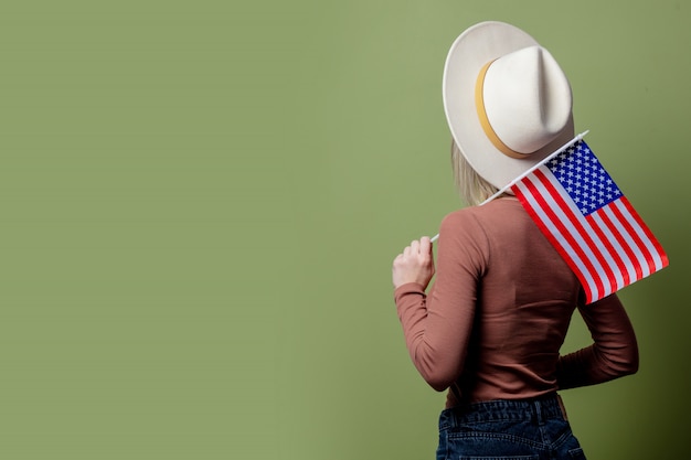 Cowgirl linda em um chapéu com bandeira dos estados unidos da américa