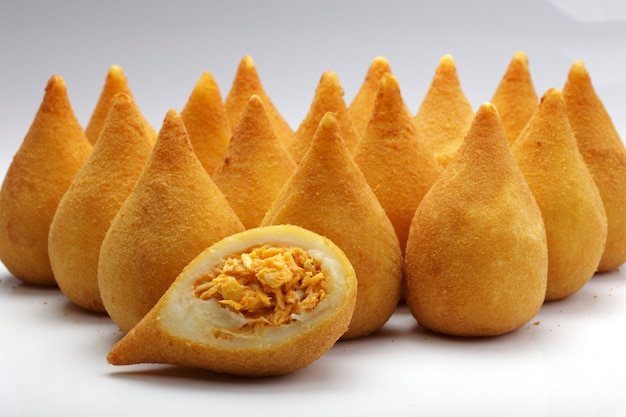 Coxinha de galinha - snack brasileiro de frango frito profundo, popular nas festas locais. servido com molho de pimenta.