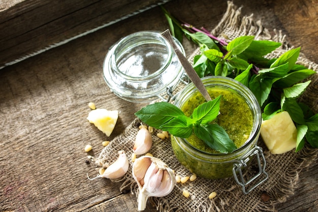 Cozinha italiana saudável molho pesto verde com ingredientes em uma mesa de madeira rústica