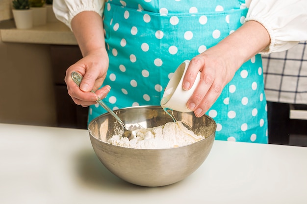 Cozinhar bolinhos de massa com purê de batatas na cozinha de casa.