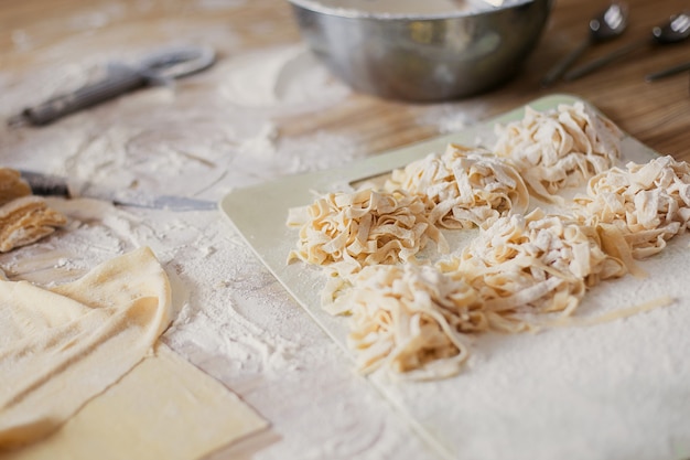 cozinhar macarrão italiano fresco com as próprias mãos em uma máquina de macarrão.