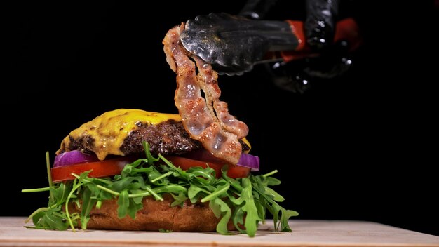 Foto craft burger kocht auf schwarzem hintergrund bestehend aus sauce aru