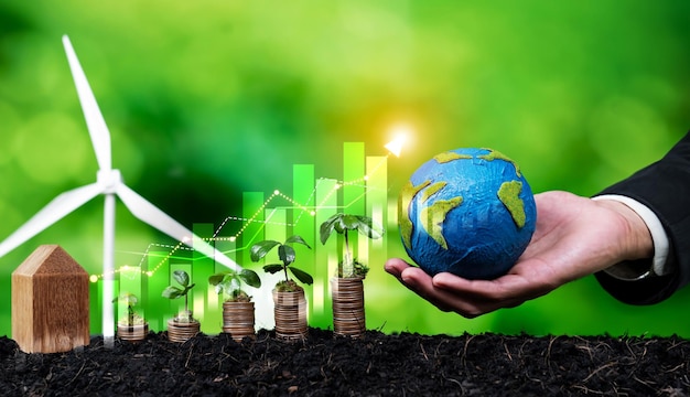 La creciente pila de monedas o dinero con el empresario ESG sostiene el globo terrestre simboliza la inversión ecológica con potencial de crecimiento sostenible que conduce a un rendimiento financiero rentable y protección del medio ambiente Reliance
