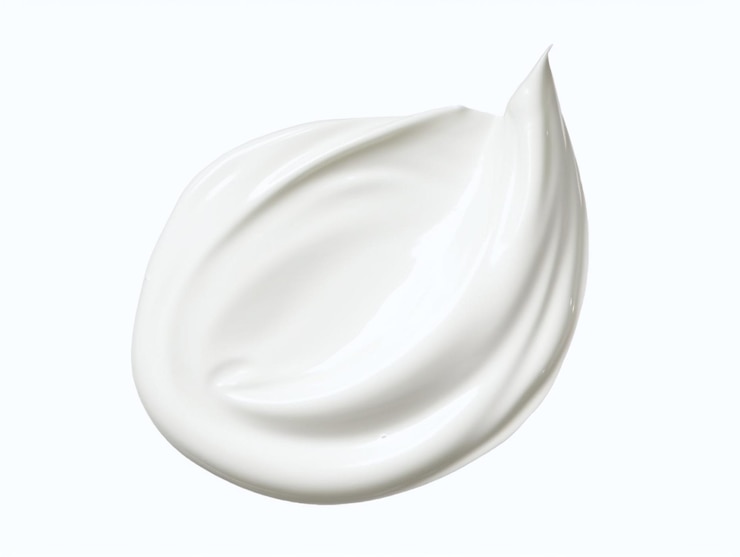Foto una crema facial blanca con un borde curvo.