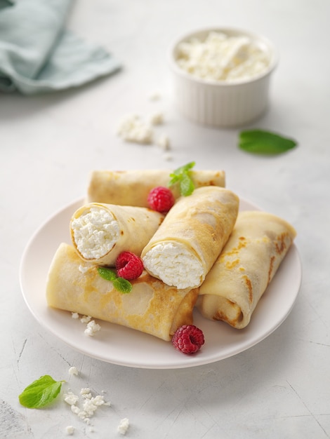 Crepes com queijo cottage, morango e hortelã. Panquecas finas com recheio. Semana da panqueca ou entrudo. Panquecas flapjack coalhada de bolo fino recheio de queijo cottage crepe.