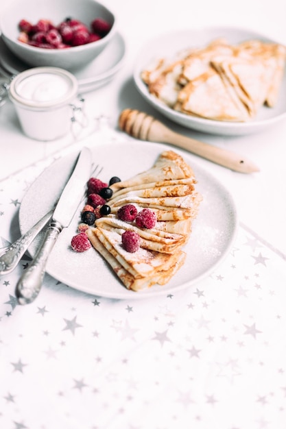 Crêpes mit hausgemachtem Hüttenkäse, Himbeeren ein grauer Teller