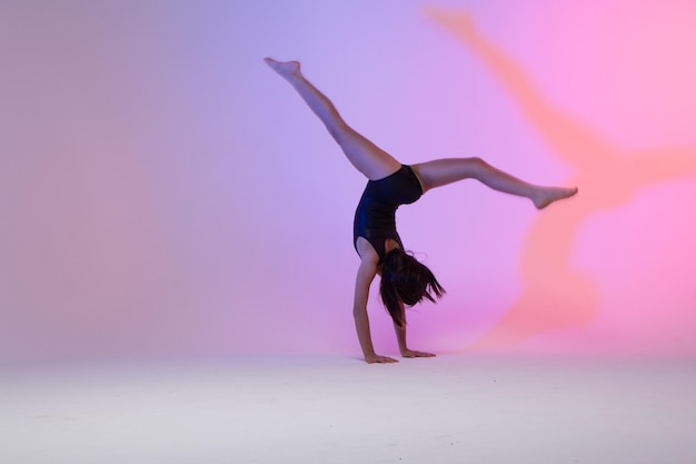 criança atleta ginasta realizando exercícios de ginástica no solo, treinamento para competição