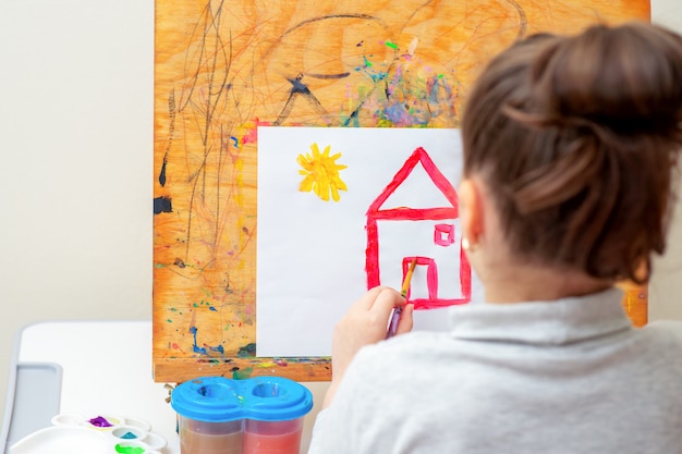 Criança está desenhando casa