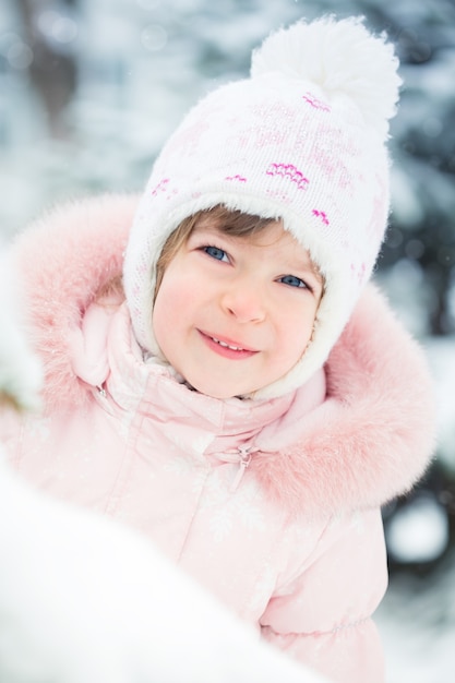 Criança feliz brincando no parque de inverno