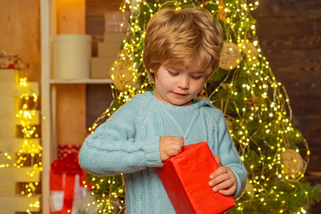 Criança feliz com o presente de Natal. Crianças de ano novo. Conceito de ano novo. Criança com um presente de Natal em