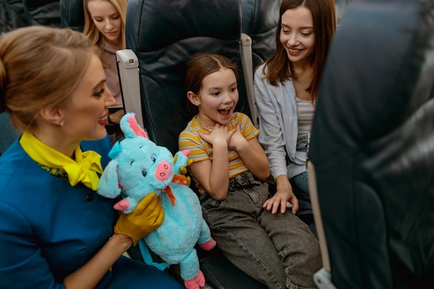 Criança feliz comemorando aniversário com mãe e aeromoça no avião