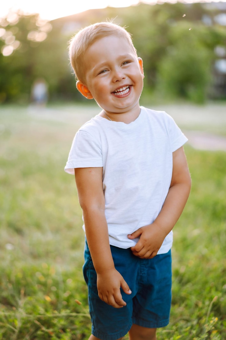 Foto criança sorridente com brinquedo no parque de verão em dia ensolarado menino bonitinho aproveitando o clima fresco da primavera