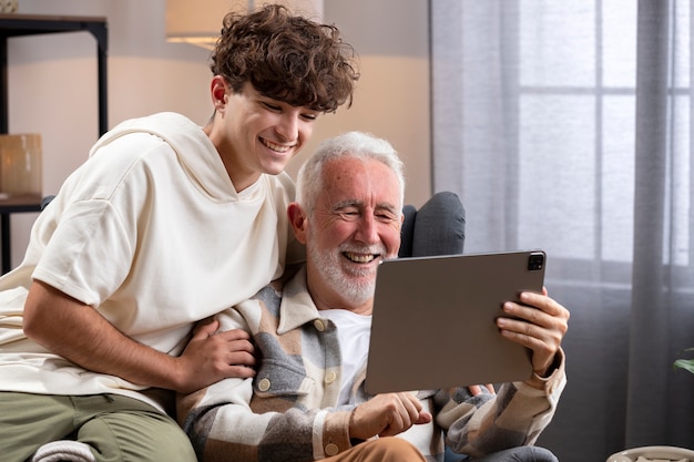 Foto criança sorridente de tiro médio e homem com tablet